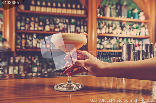 Image of The girl is holding in his hand a glass of alcoholic beverage