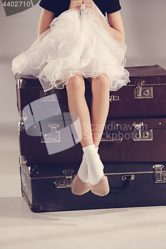 Image of The little girl as balerina dancer sitting at studio