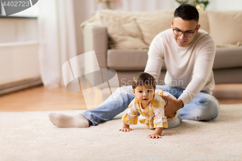 Image of happy father with little baby daughter at home