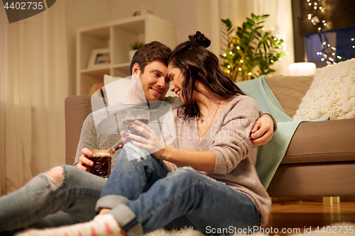 Image of happy couple drinking coffee and eating at home