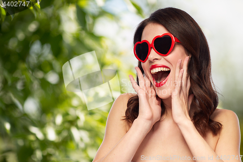 Image of woman with red lipstick and heart shaped shades