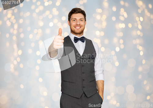 Image of happy man in festive suit showing thumbs up