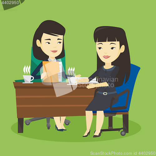 Image of Two businesswomen during business meeting.