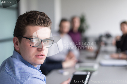 Image of Businessman using tablet in modern office