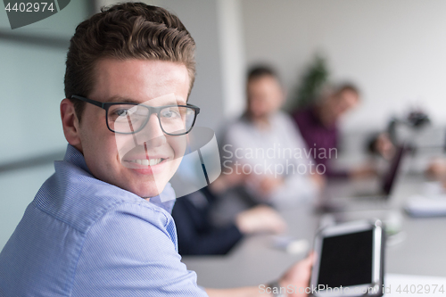 Image of Businessman using tablet in modern office