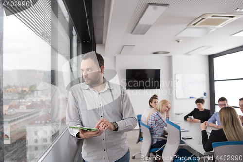 Image of Businessman Using Tablet In Office Building by window