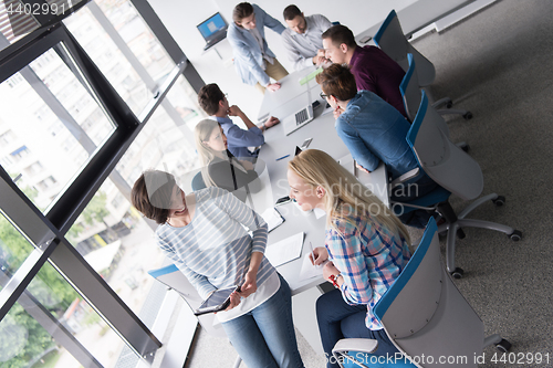 Image of Pretty Businesswomen Using Tablet In Office Building during conf
