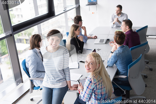 Image of Pretty Businesswomen Using Tablet In Office Building during conf