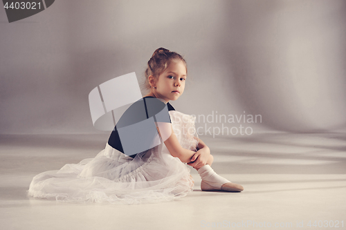 Image of The little balerina dancer on gray background