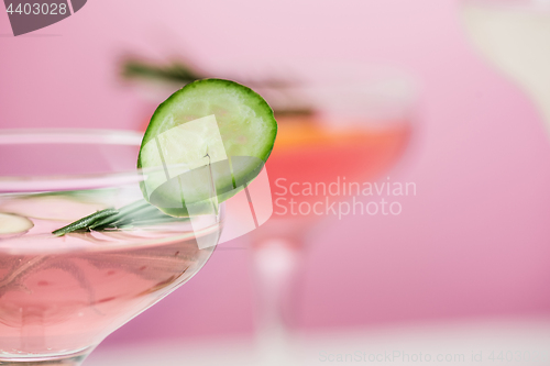 Image of The rose exotic cocktails and fruits on pink