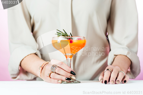 Image of The rose exotic cocktails and fruits and female hand