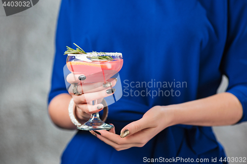 Image of The exotic cocktail and female hands