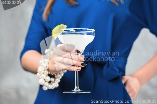 Image of The exotic cocktail and female hands