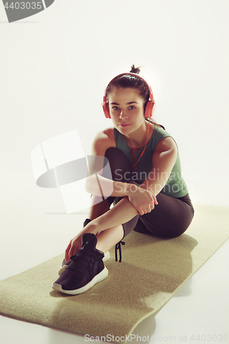 Image of Front view of a young woman sitting with headphones