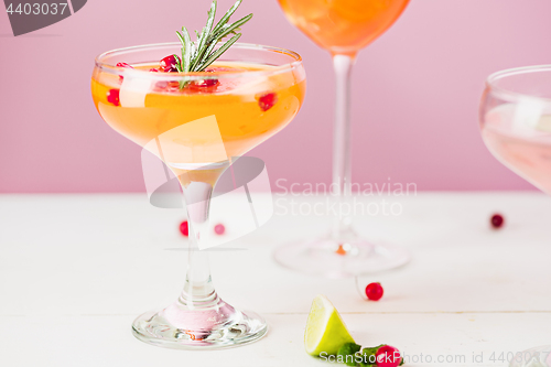 Image of The rose exotic cocktails and fruits on pink