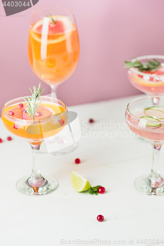 Image of The rose exotic cocktails and fruits on pink