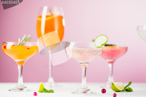 Image of The rose exotic cocktails and fruits on pink