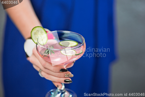 Image of The exotic cocktail and female hands