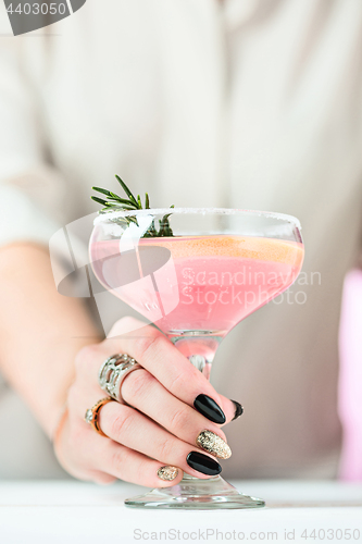 Image of The rose exotic cocktails and fruits and female hand