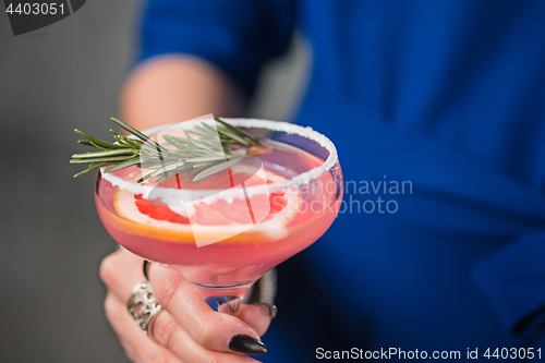 Image of The exotic cocktail and female hands