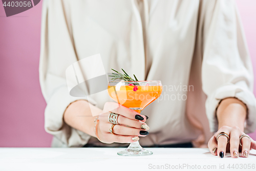 Image of The rose exotic cocktails and fruits and female hand