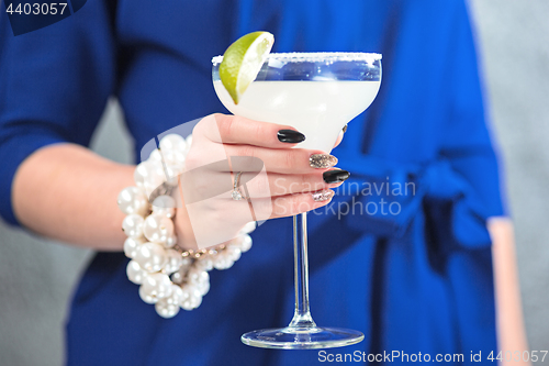 Image of The exotic cocktail and female hands