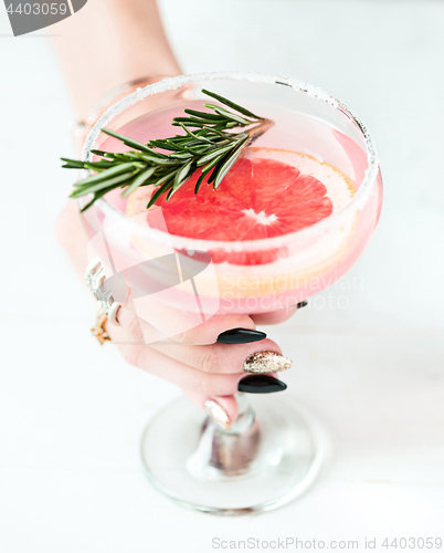 Image of The rose exotic cocktails and fruits and female hand