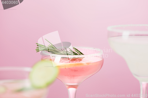 Image of The rose exotic cocktails and fruits on pink