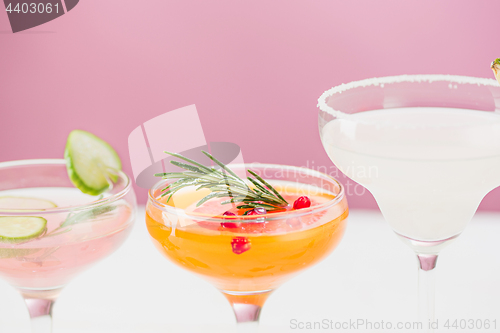 Image of The rose exotic cocktails and fruits on pink