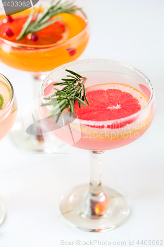 Image of The rose exotic cocktails and fruits on pink