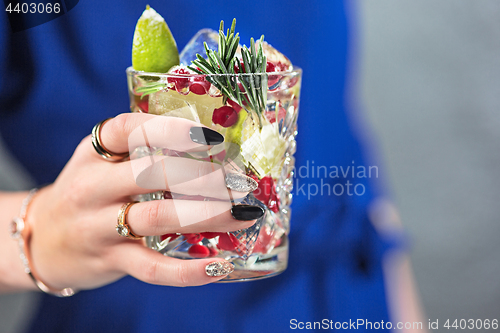 Image of The exotic cocktail and female hands
