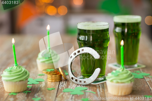 Image of glasses of beer, cupcakes, horseshoe and coins