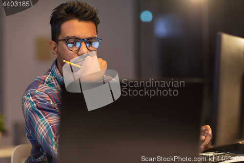 Image of close up of creative man working at night office