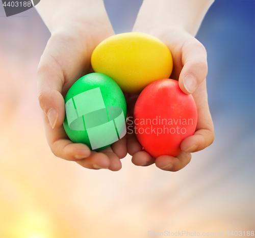 Image of close up of girl holding colored easter eggs