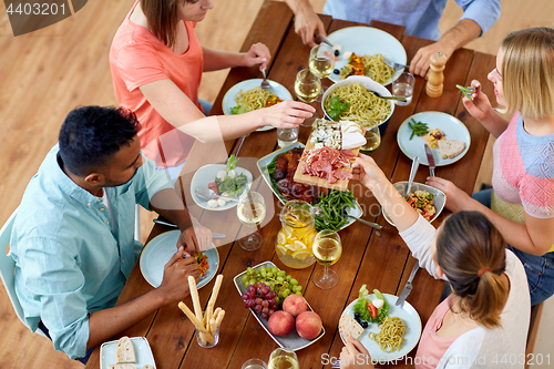 Image of group of people eating at table with food