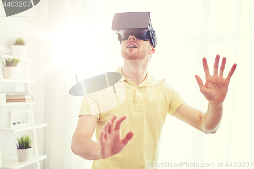 Image of young man in virtual reality headset or 3d glasses