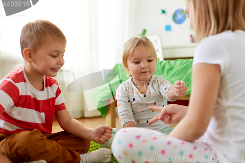 Image of kids playing rock-paper-scissors game at home