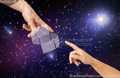 Image of close up of senior and young woman hands