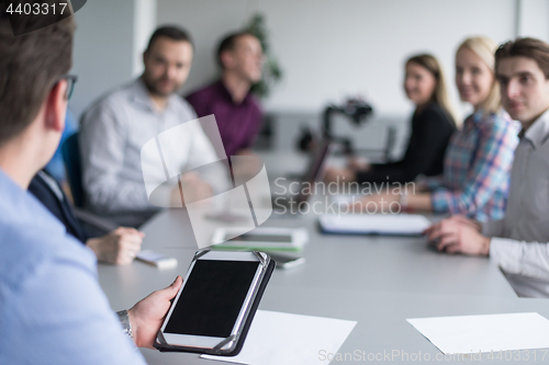 Image of Businessman using tablet in modern office