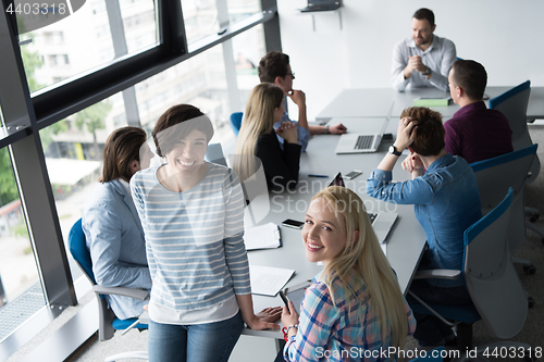 Image of Pretty Businesswomen Using Tablet In Office Building during conf