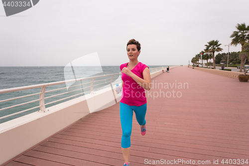 Image of woman busy running on the promenade