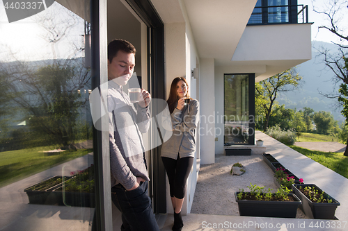 Image of couple enjoying on the door of their luxury home villa