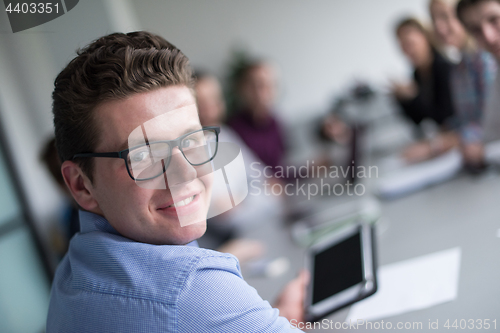 Image of Businessman using tablet in modern office