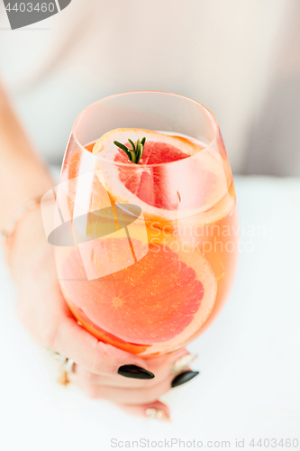 Image of The rose exotic cocktails and fruits and female hand