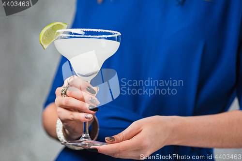 Image of The exotic cocktail and female hands