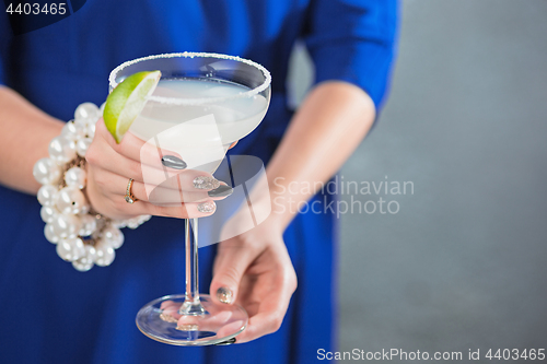 Image of The exotic cocktail and female hands