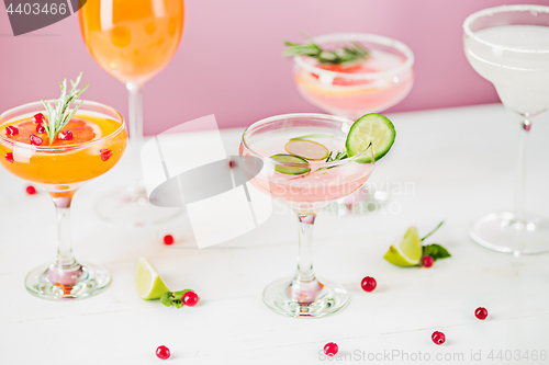 Image of The rose exotic cocktails and fruits on pink