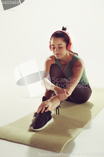 Image of Front view of a young woman sitting with headphones