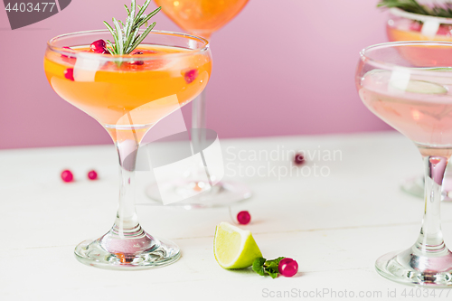 Image of The rose exotic cocktails and fruits on pink