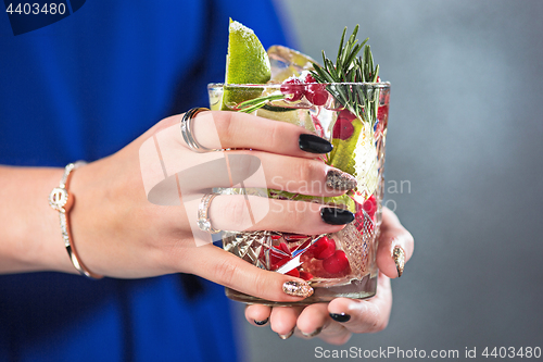 Image of The exotic cocktail and female hands